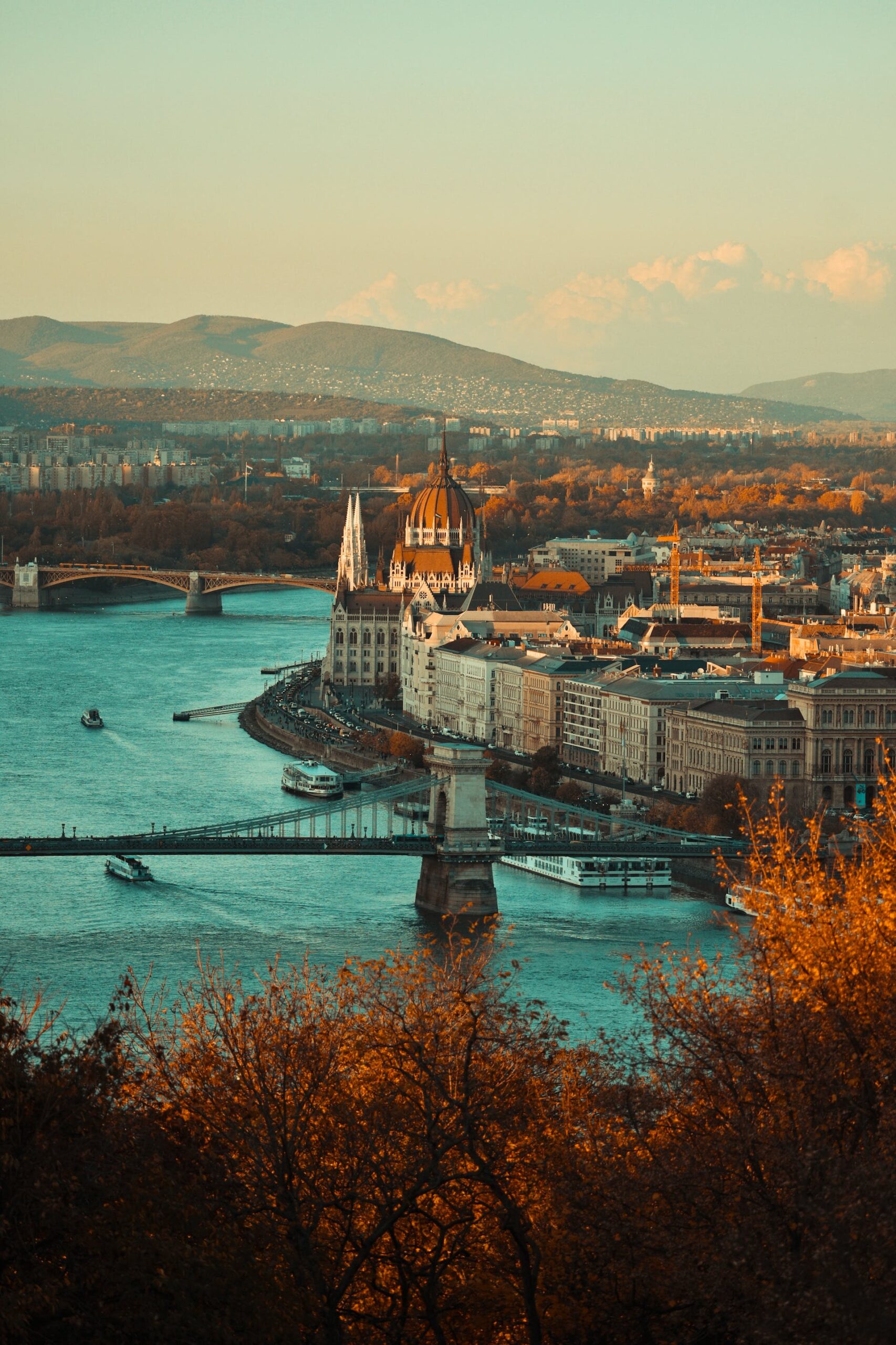 A serene image of Budapest's iconic thermal baths surrounded by lush greenery, offering a peaceful escape for a wellness break