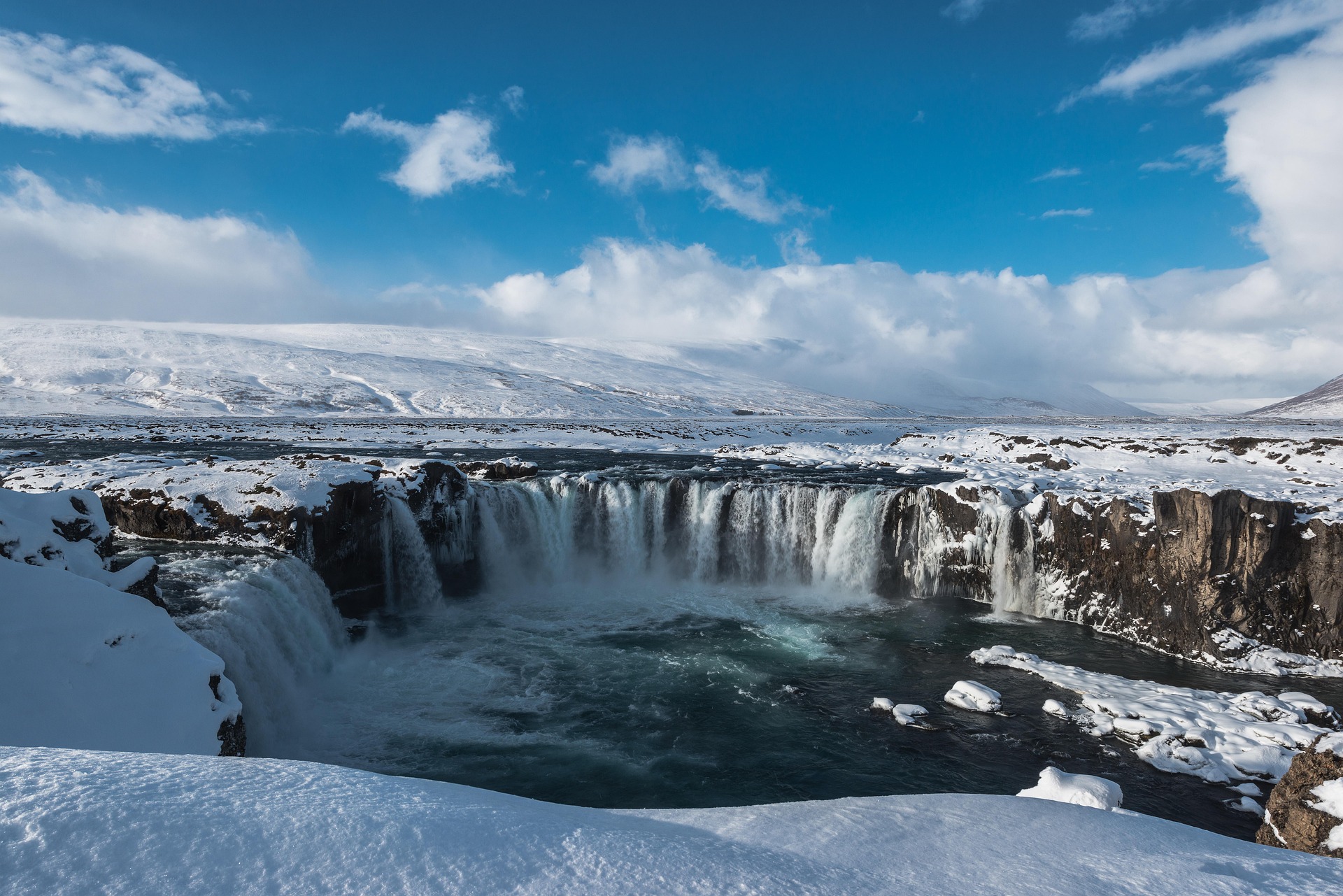 Captivating waterfall in Reykjavik, Iceland, surrounded by stunning natural scenery, exemplifying the majestic beauty of the Icelandic landscape