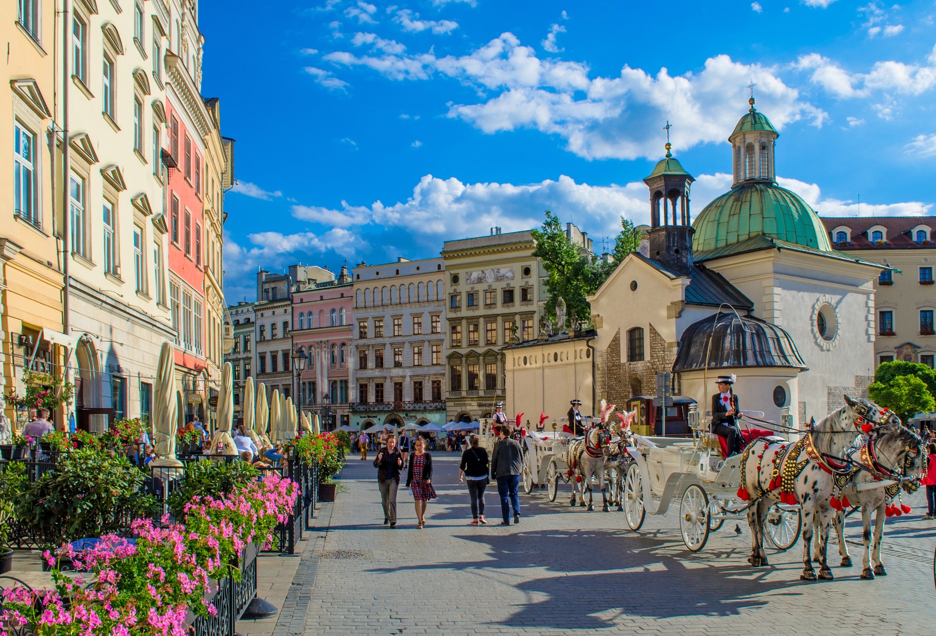 Aerial view of Krakow, Poland, showcasing its historic architecture, including the iconic Wawel Castle, colorful buildings, and bustling streets