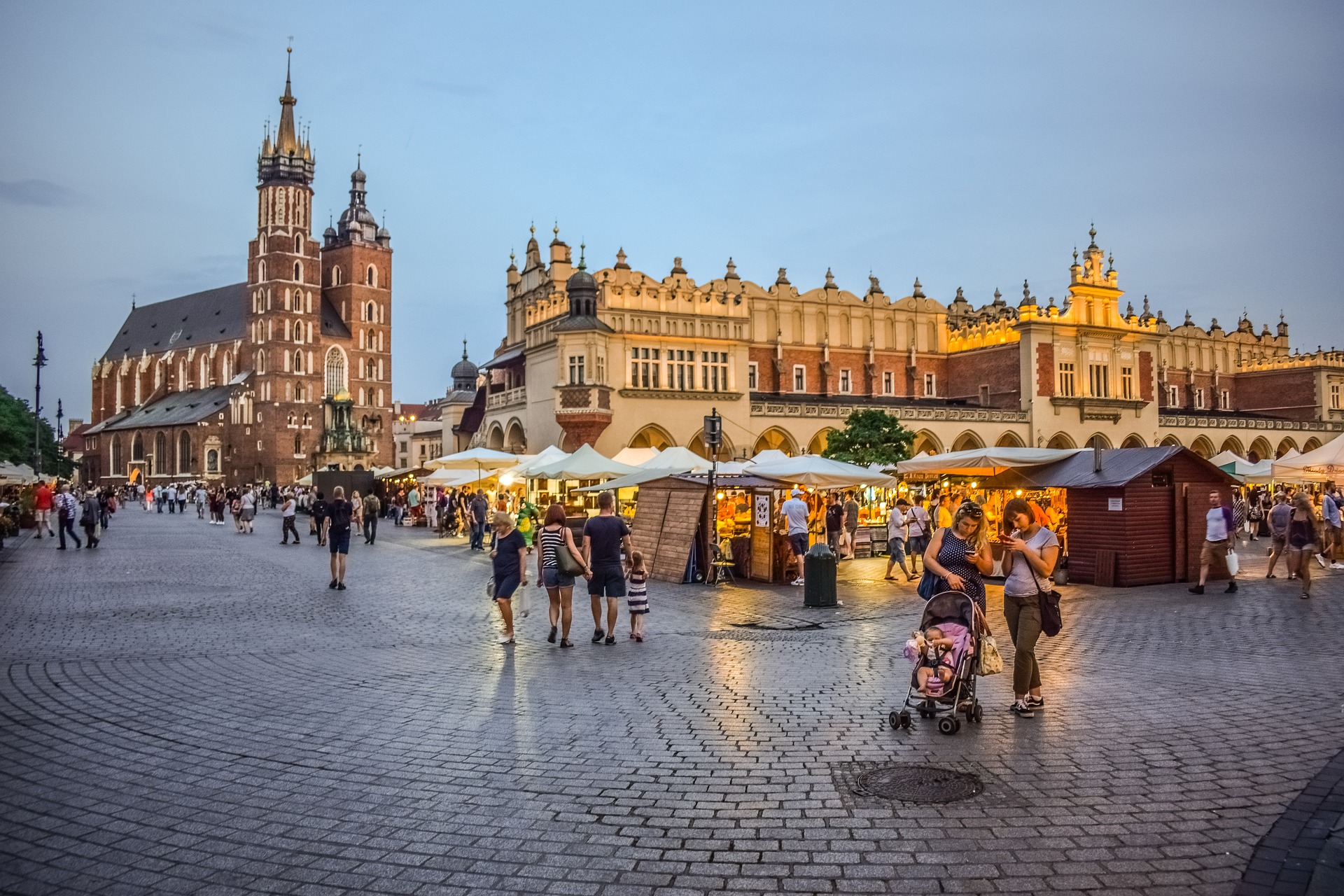 A vibrant scene of bustling streets and crowded squares in Krakow, Poland, depicting the lively atmosphere and energetic pace of urban life in the city.