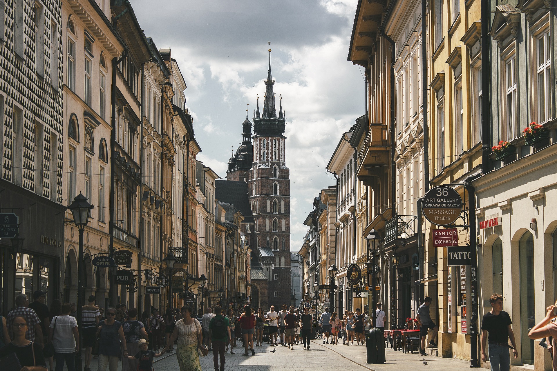An aerial view of Krakow's bustling city center, with busy streets filled with pedestrians, cars, and cyclists, showcasing the vibrant energy and dynamic rhythm of daily life in the historic Polish town