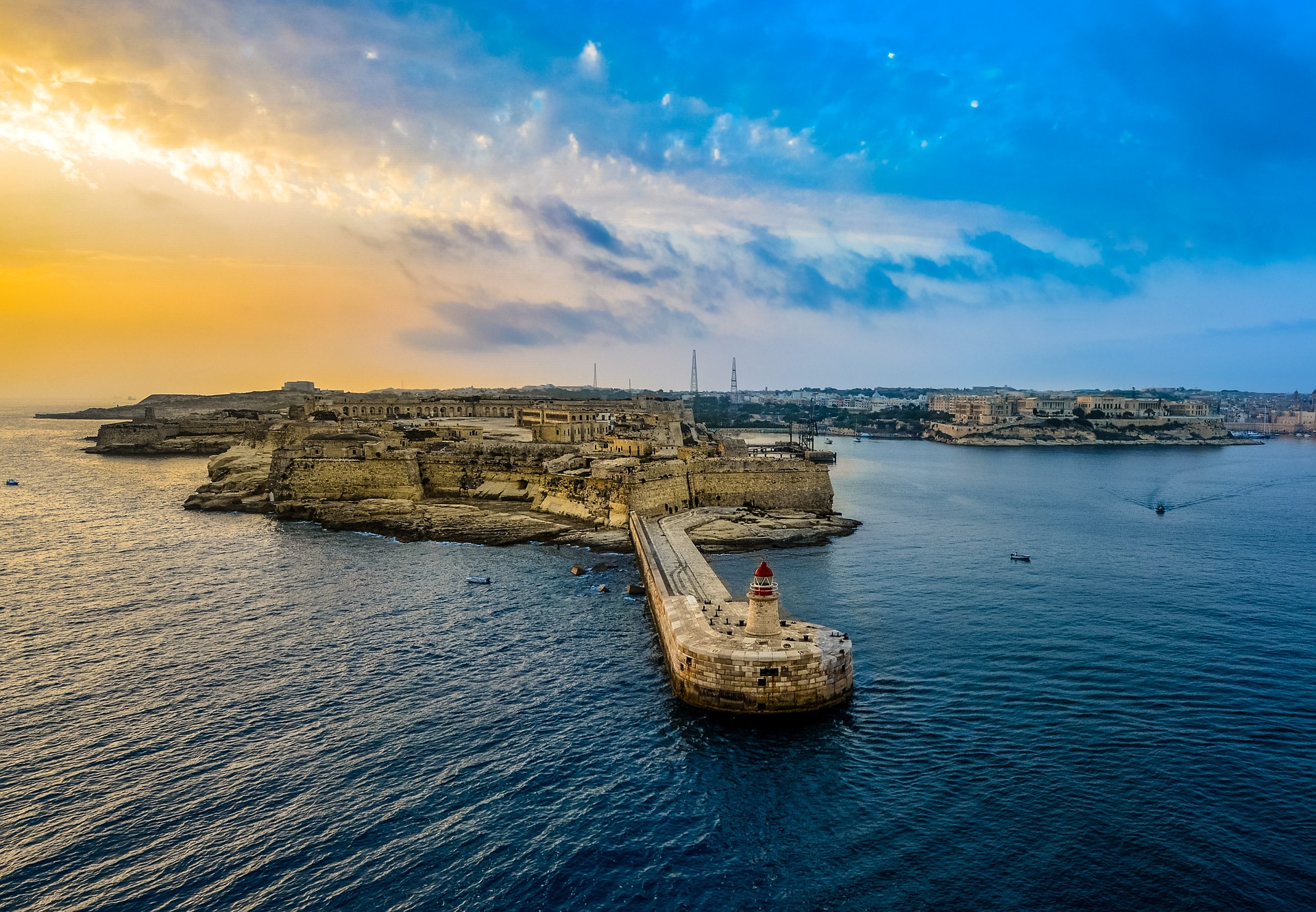 Sunny Retreat in Malta | Spectacular view of a sun-kissed beach in Malta, offering the perfect setting for a sunny retreat in this Mediterranean paradise