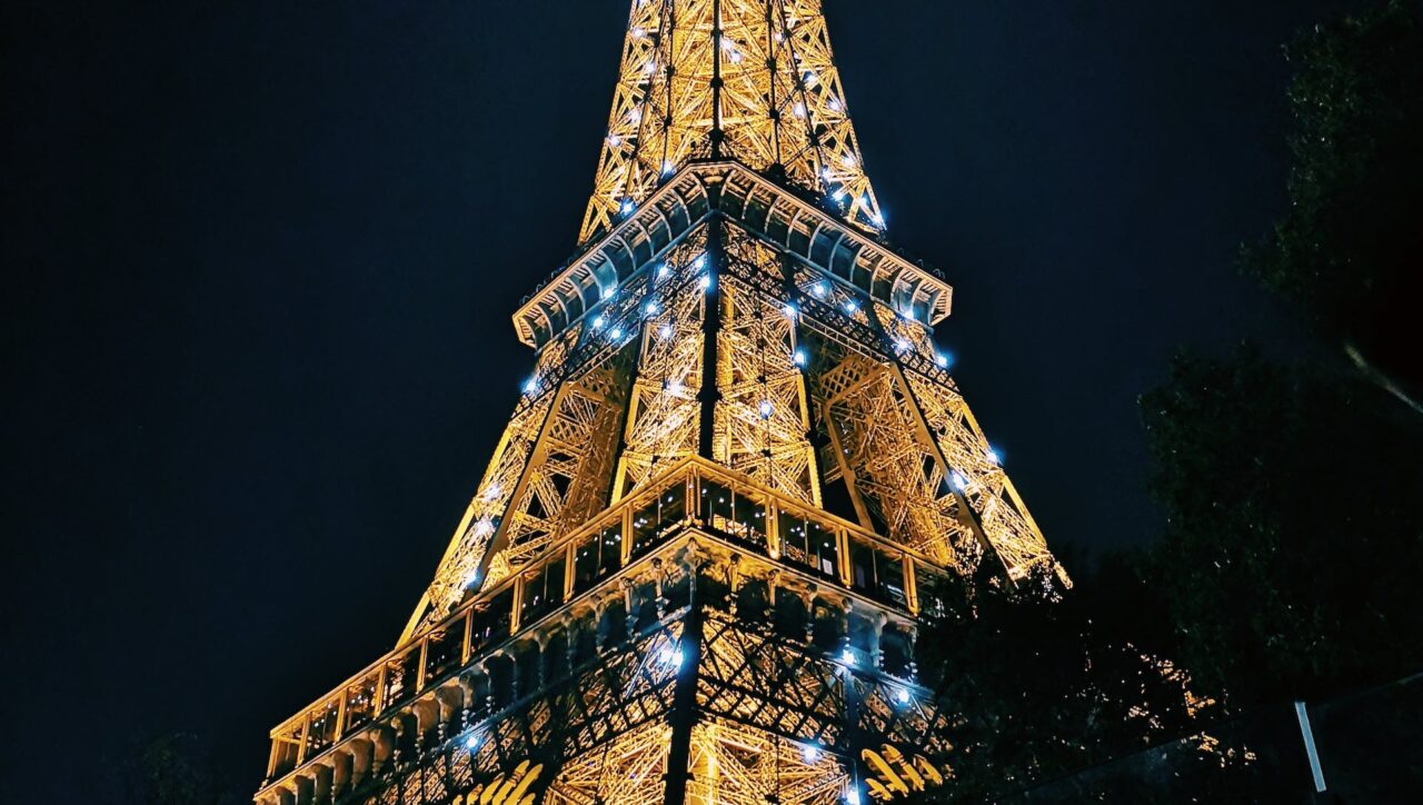 Paris Sparkle with Disney Charm | Iconic Eiffel Tower illuminated against the night sky, representing the enchanting allure of Paris Sparkle with Disney Charm."